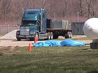 Truck and shipping container leaving Plum Brook Reactor