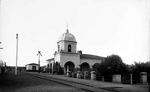 (PD) Photo: William Henry JacksonOne of the earliest examples of "Mission Revival Style" architecture, the Atchison, Topeka and Santa Fe Railway depot in San Juan Capistrano (with its 40-foot [12-meter] high dome and bell) was considered to be one of the railroad's finest when it was completed on October 8, 1894; it officially entered service on October 27 of that year.[8] The San Juan Capistrano station has remained in use and today is served by Amtrak, the national railroad passenger system, and Metrolink, a commuter railroad.