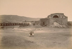 (PD) Photo: Carlton Watkins The ruins of Mission San Juan Capistrano, circa 1877. A small group of people poses in the foreground.