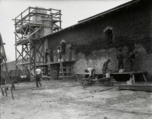 (PD) Photo: National Park Service Civilian Conservation Corps crew members apply cement plaster to the adobe chapel walls at Mission La Purísima Concepción.